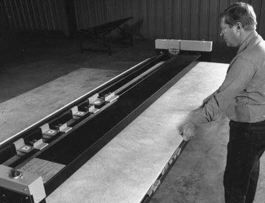Fig. 11. Machine grooving fibrous glass duct board
