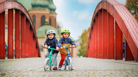 2 Young boys riding the Kinderkraft Balance Bike RAPID